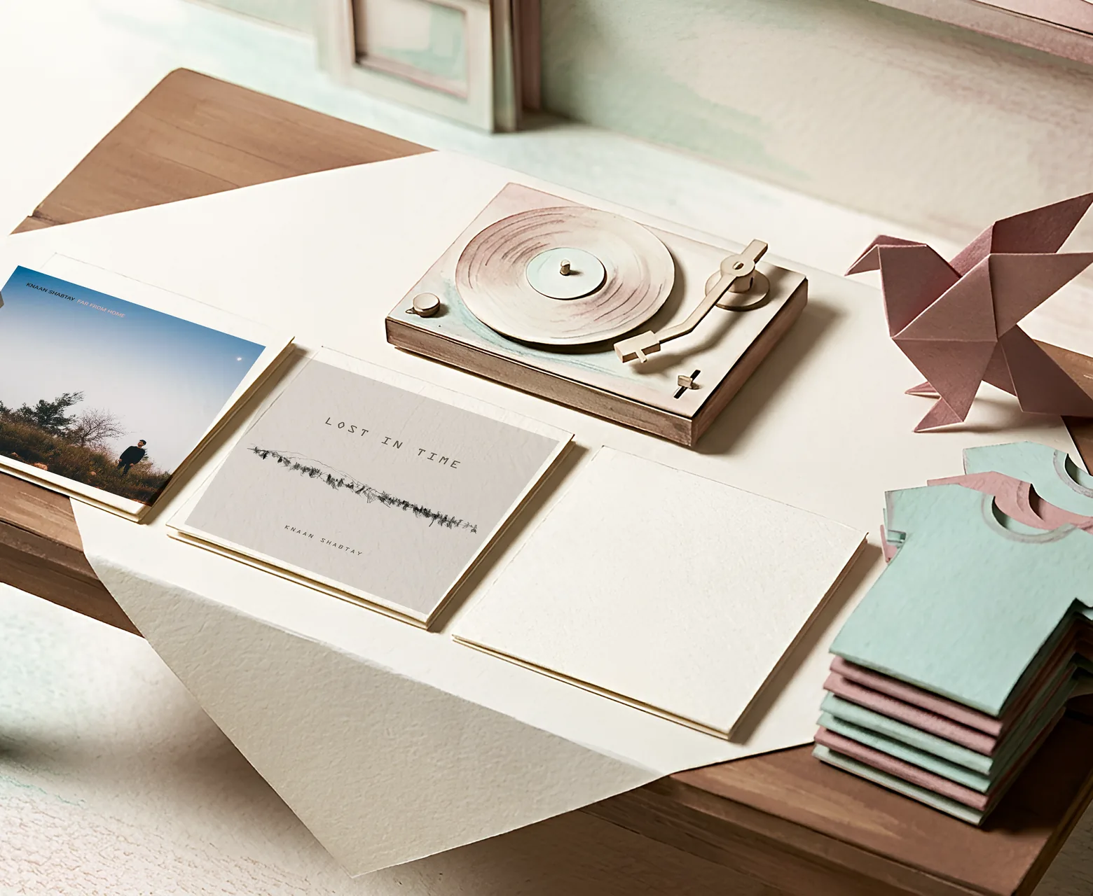 Paper merch table with a turntable and records